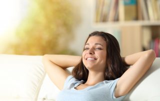 Lady enjoying her new HVAC System - Top 5 Benefits of Replacing Your HVAC System